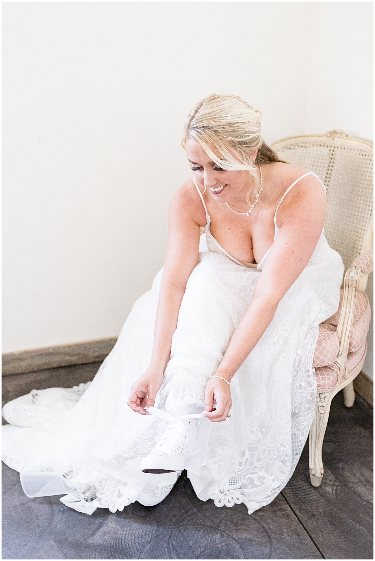 Bride putting on sneakers for Finley Creek Vineyards wedding in Zionsville, Indiana