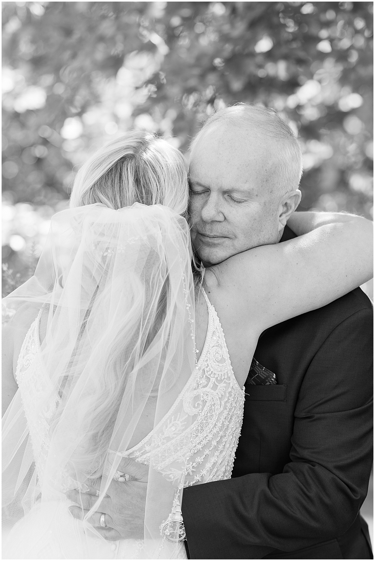Father hugs bride before Finley Creek Vineyards wedding in Zionsville, Indiana