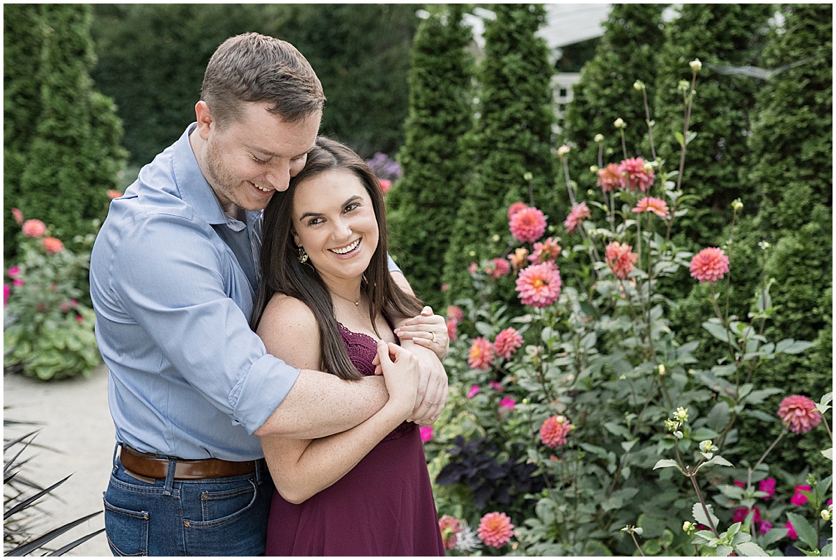 Couple in garden during jewel tone engagement photos at Newfields
