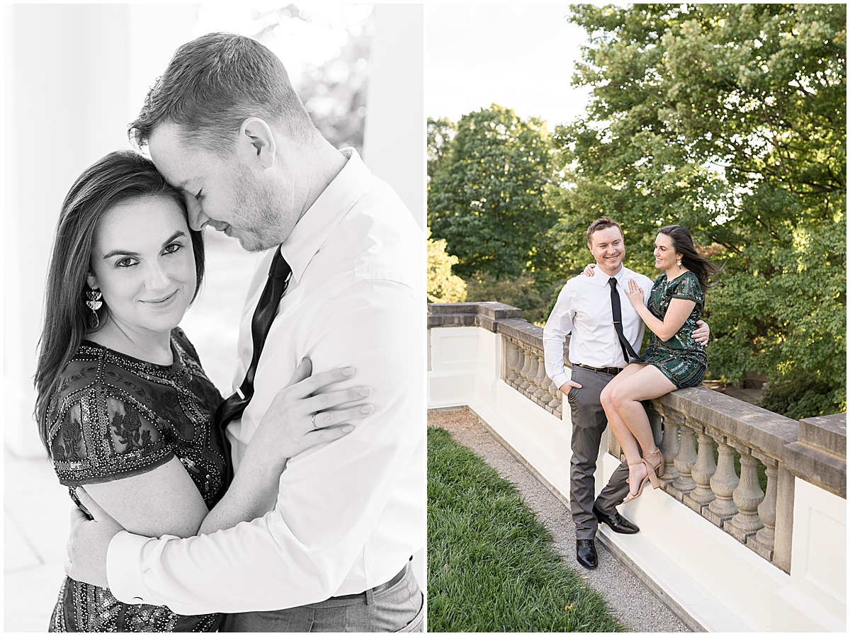 Couple sits on stone railing at jewel tone engagement photos at Newfields