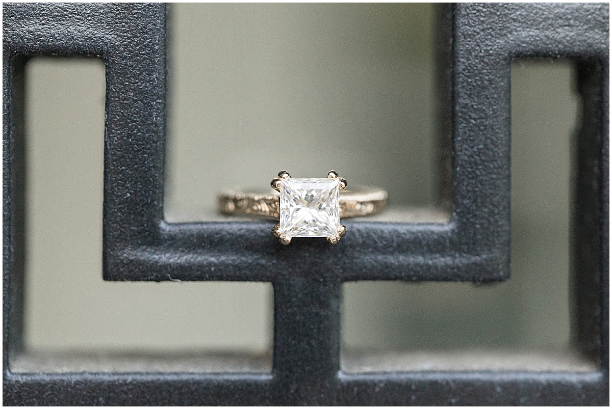 Close up of ring on black railing at jewel tone engagement photos at Newfields