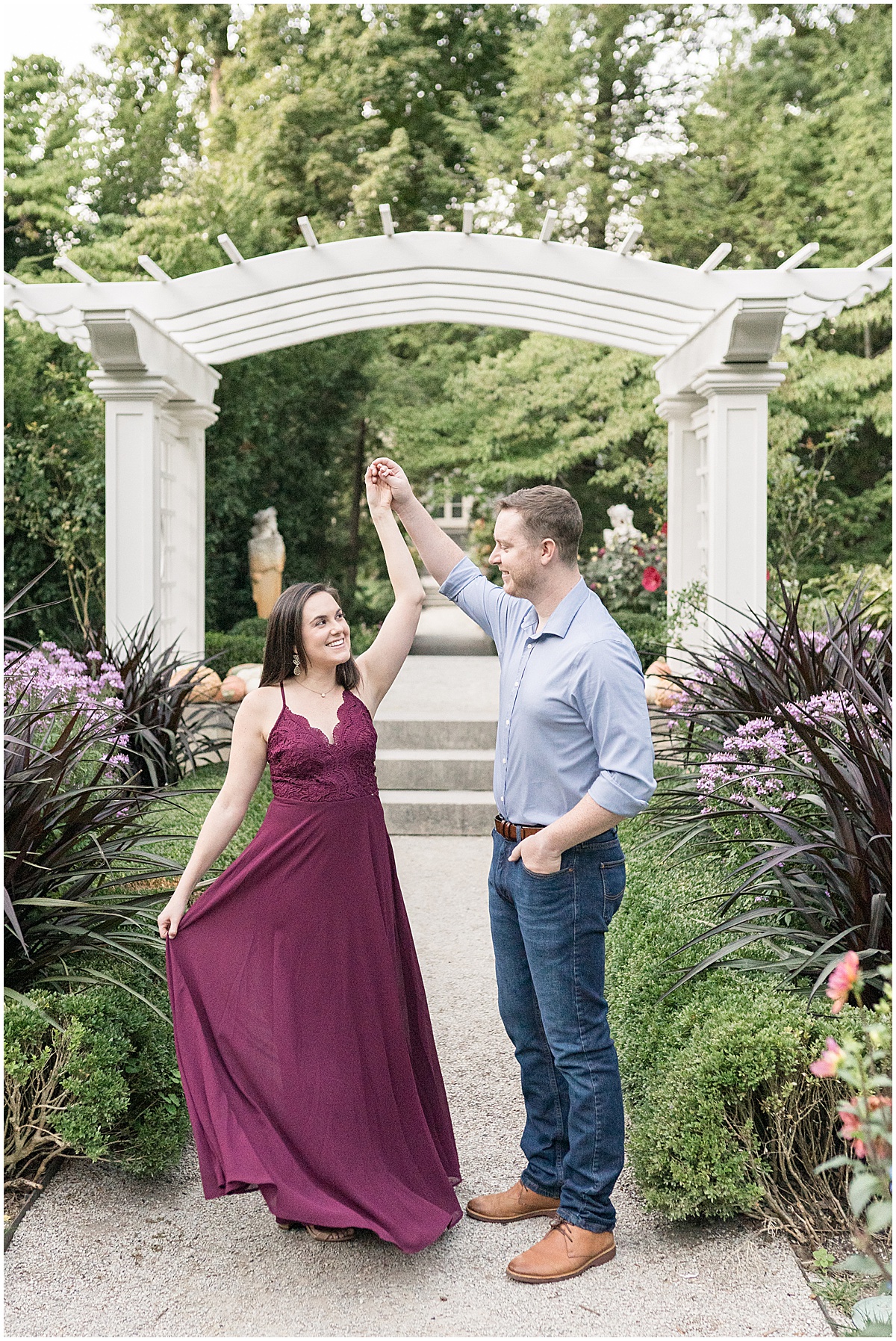 Couple dancing in garden at jewel tone engagement photos at Newfields
