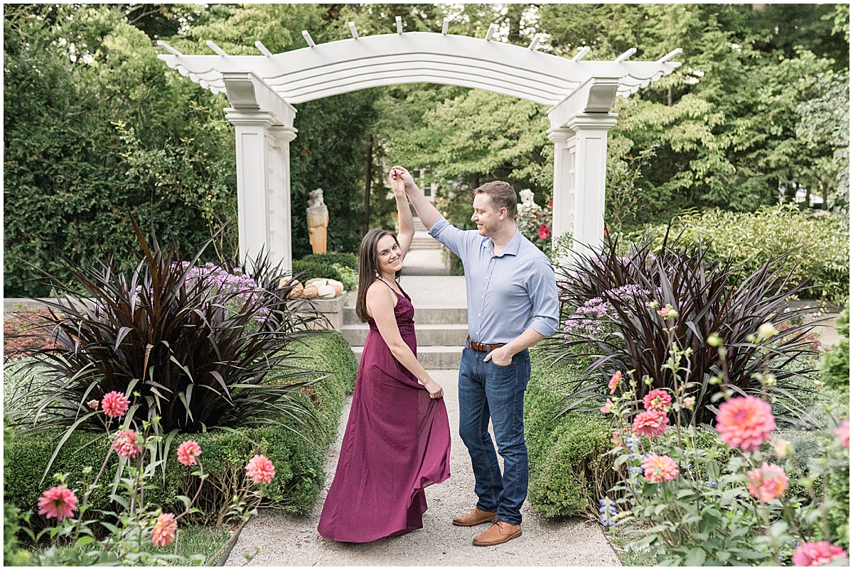 Couple dancing at jewel tone engagement photos at Newfields