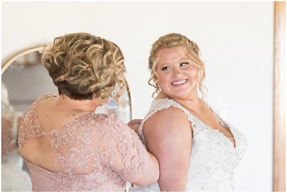 Bride getting ready with mother before Miami County Fairgrounds wedding in Peru, Indiana