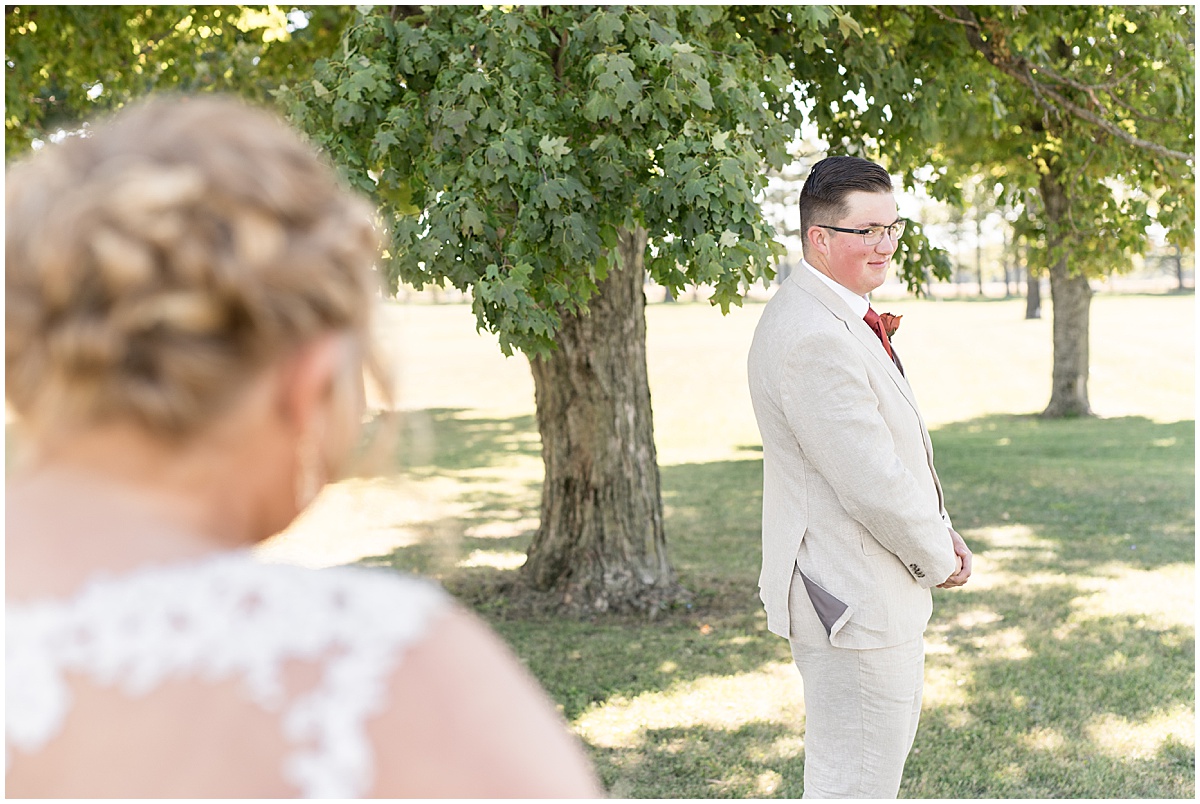 First look with bride and groom before Miami County Fairgrounds wedding in Peru, Indiana
