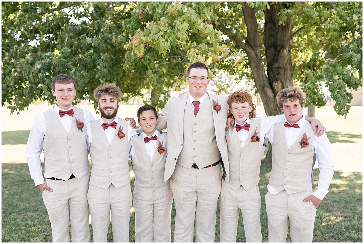 Groom with groomsmen in tan suits for Miami County Fairgrounds wedding in Peru, Indiana