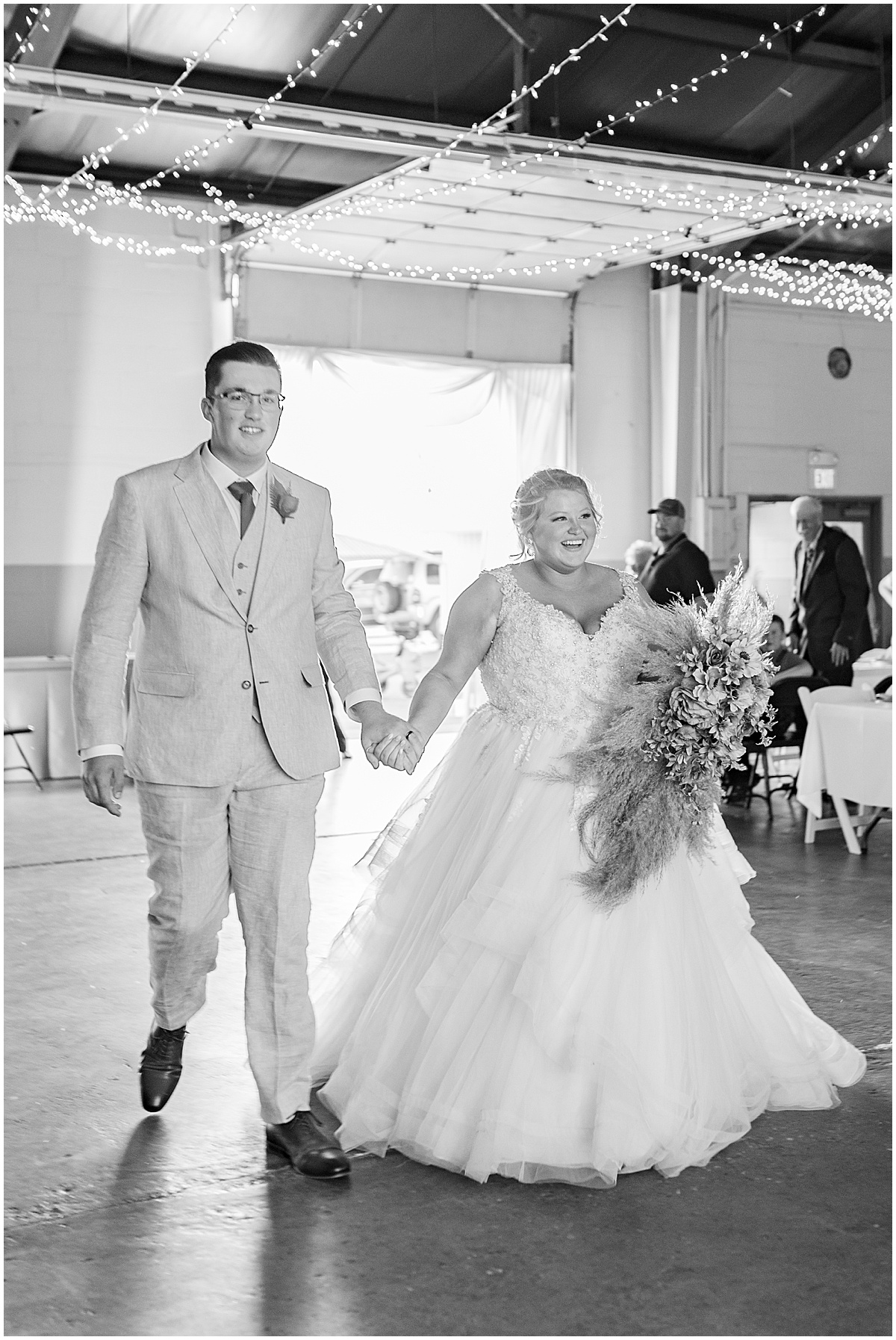 Bride and groom enter reception at Miami County Fairgrounds wedding in Peru, Indiana