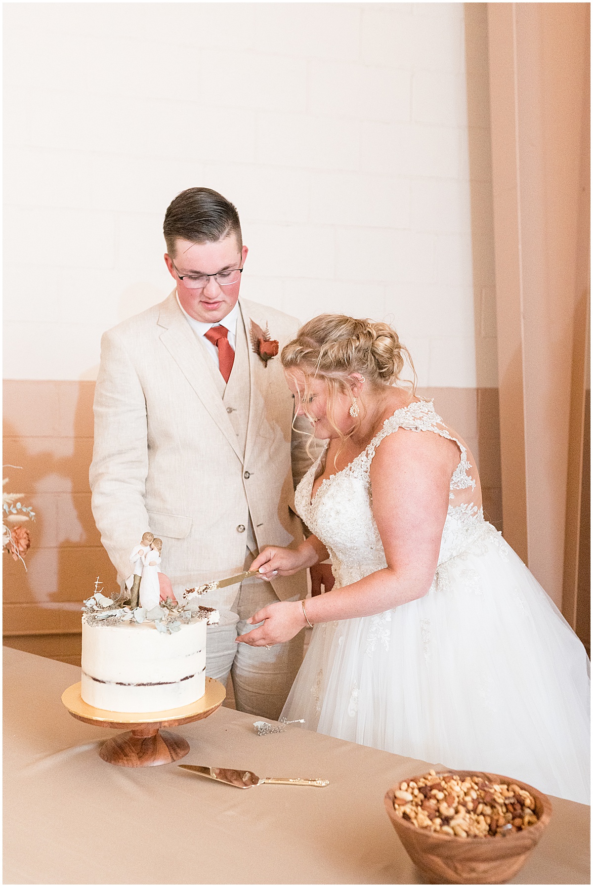 Cutting the cake at Miami County Fairgrounds wedding in Peru, Indiana