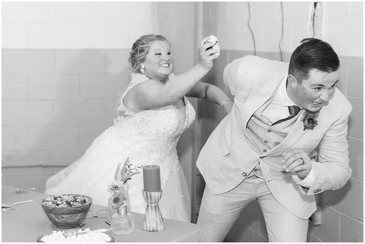 Bride attempts to smash cake on groom at Miami County Fairgrounds wedding in Peru, Indiana 
