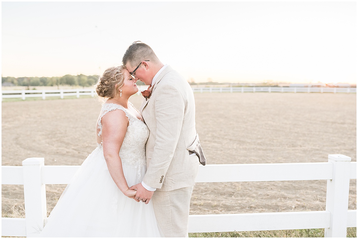 Bride and groom embrace during sunset at Miami County Fairgrounds wedding in Peru, Indiana