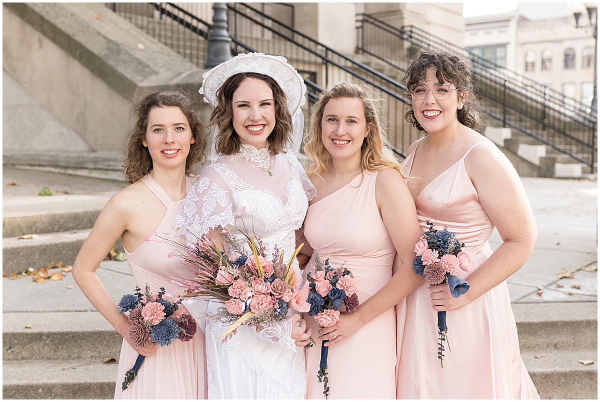 Bride with bridesmaids in pink at wedding photos in Downtown Lafayette, Indiana