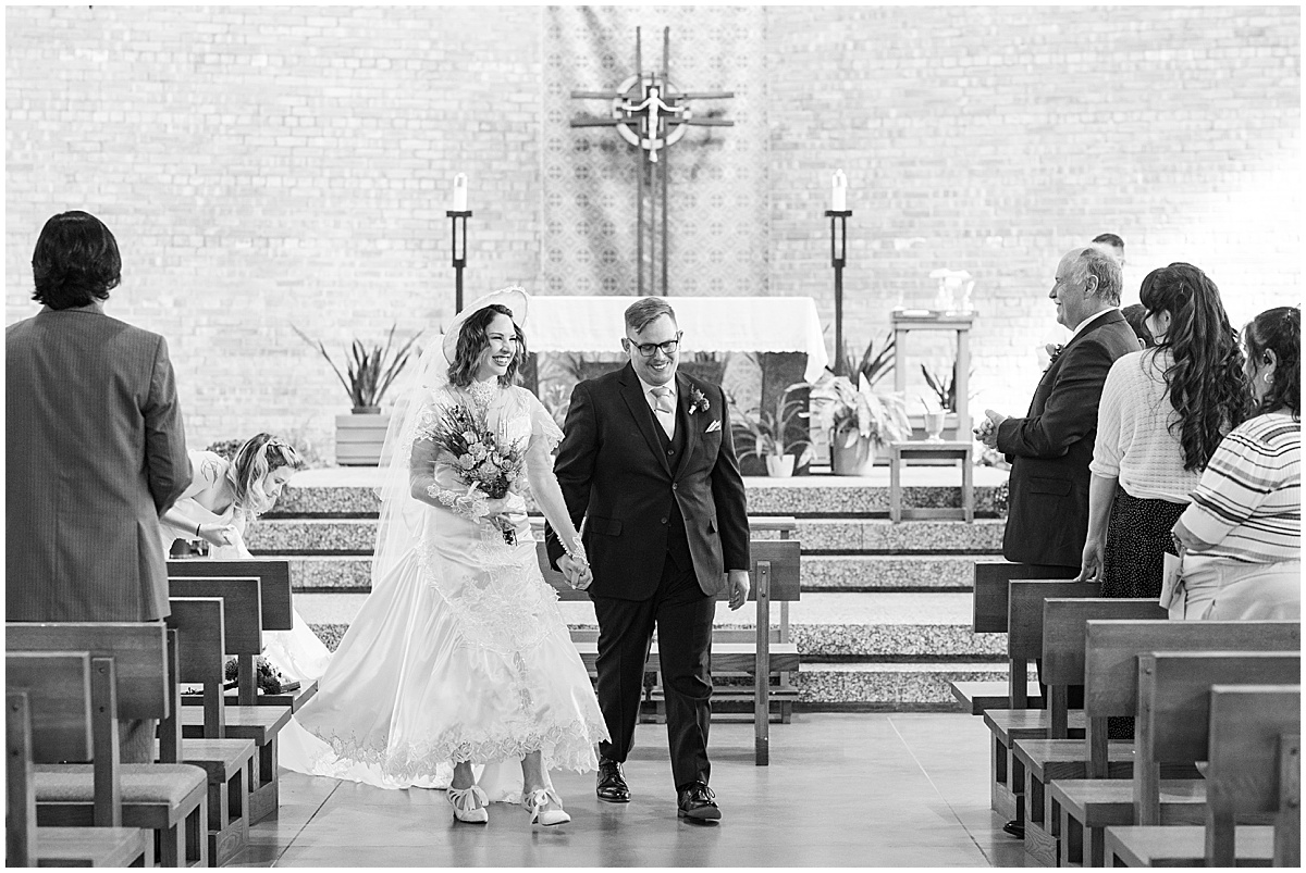 Bride and groom exit from wedding at St. Thomas Aquina Church in West Lafayette, Indiana