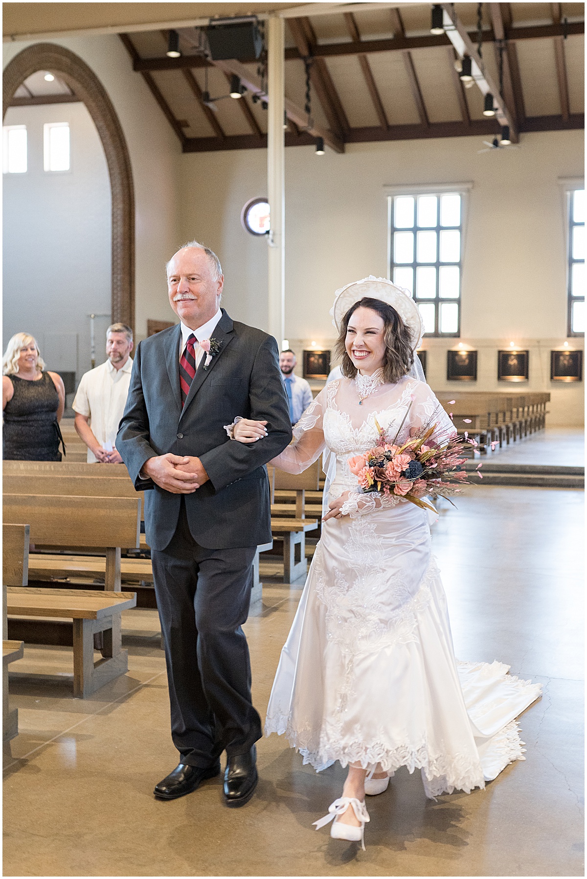 Bride walk down aisle at wedding at St. Thomas Aquina Church in West Lafayette, Indiana