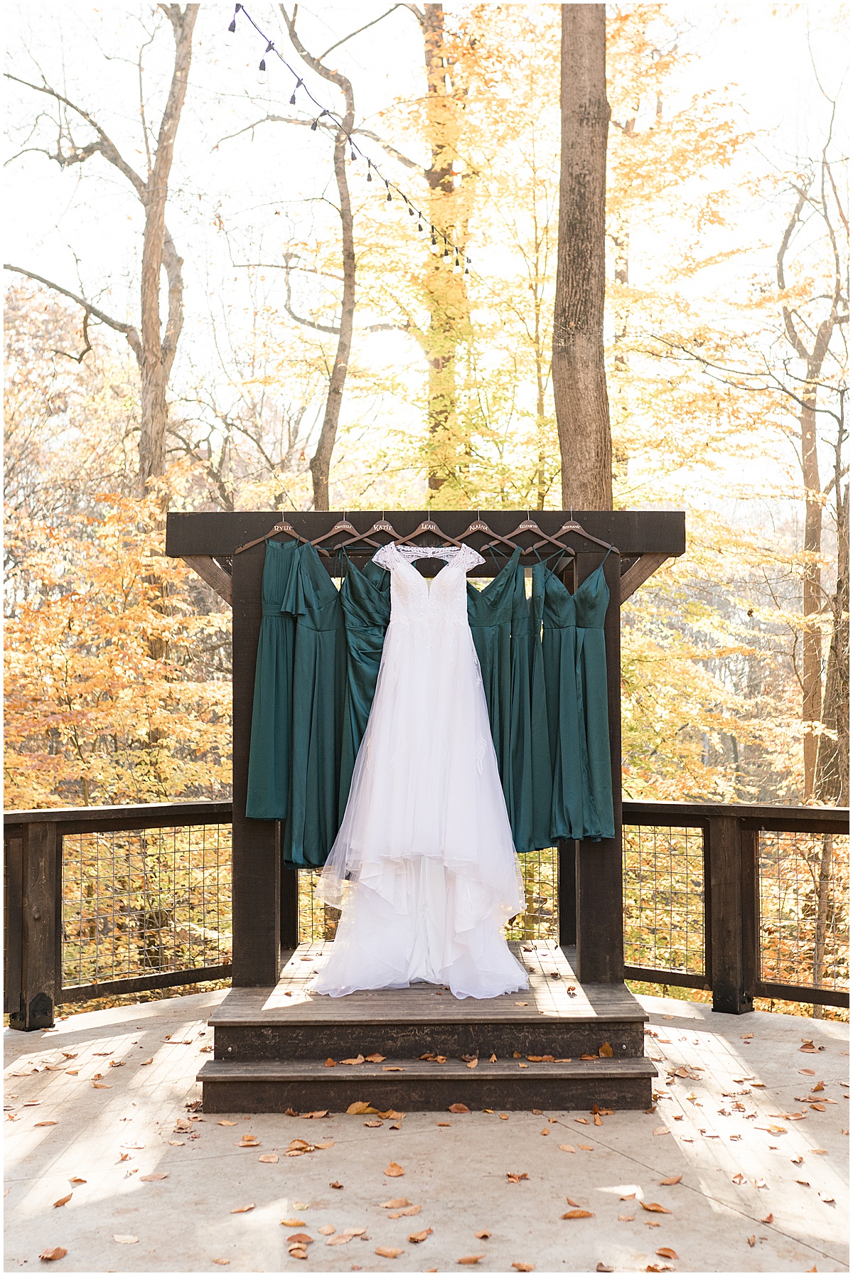 Wedding dress hanging in front of fall leaves at fall wedding at 3 Fat Labs in Greencastle, Indiana