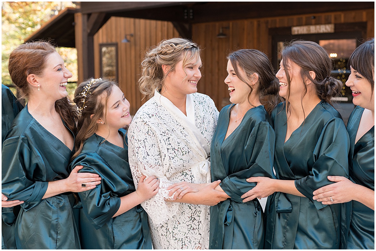Bride with bridesmaids in robes before fall wedding at 3 Fat Labs in Greencastle, Indiana
