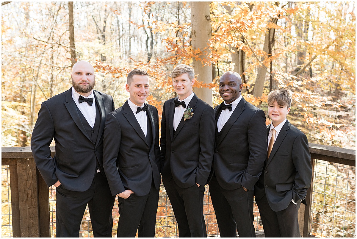 Groom with groomsmen in front of fall leaves for fall wedding at 3 Fat Labs in Greencastle, Indiana
