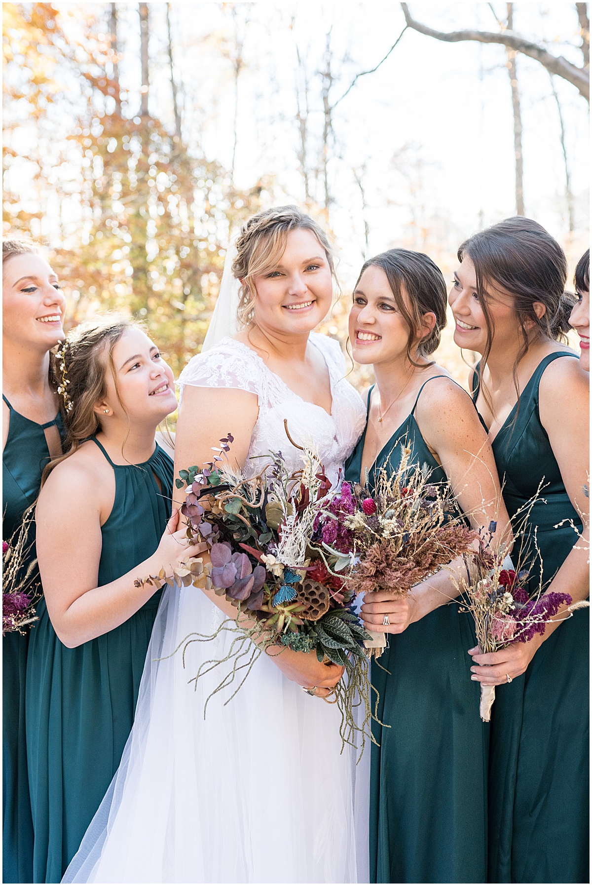 Bride laughing with bridesmaids before fall wedding at 3 Fat Labs in Greencastle, Indiana