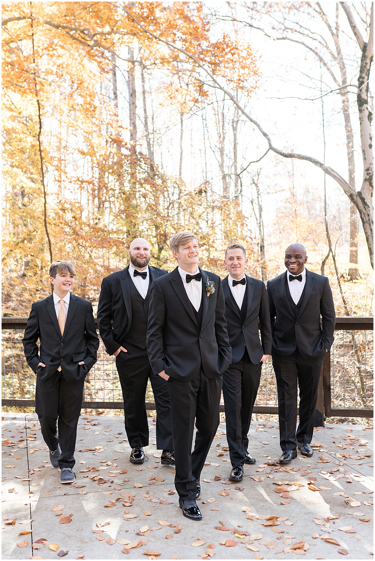 Groomsmen walk in fall leaves for fall wedding at 3 Fat Labs in Greencastle, Indiana