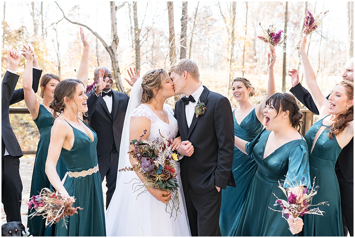 Bridal party celebrate the couple at fall wedding at 3 Fat Labs in Greencastle, Indiana