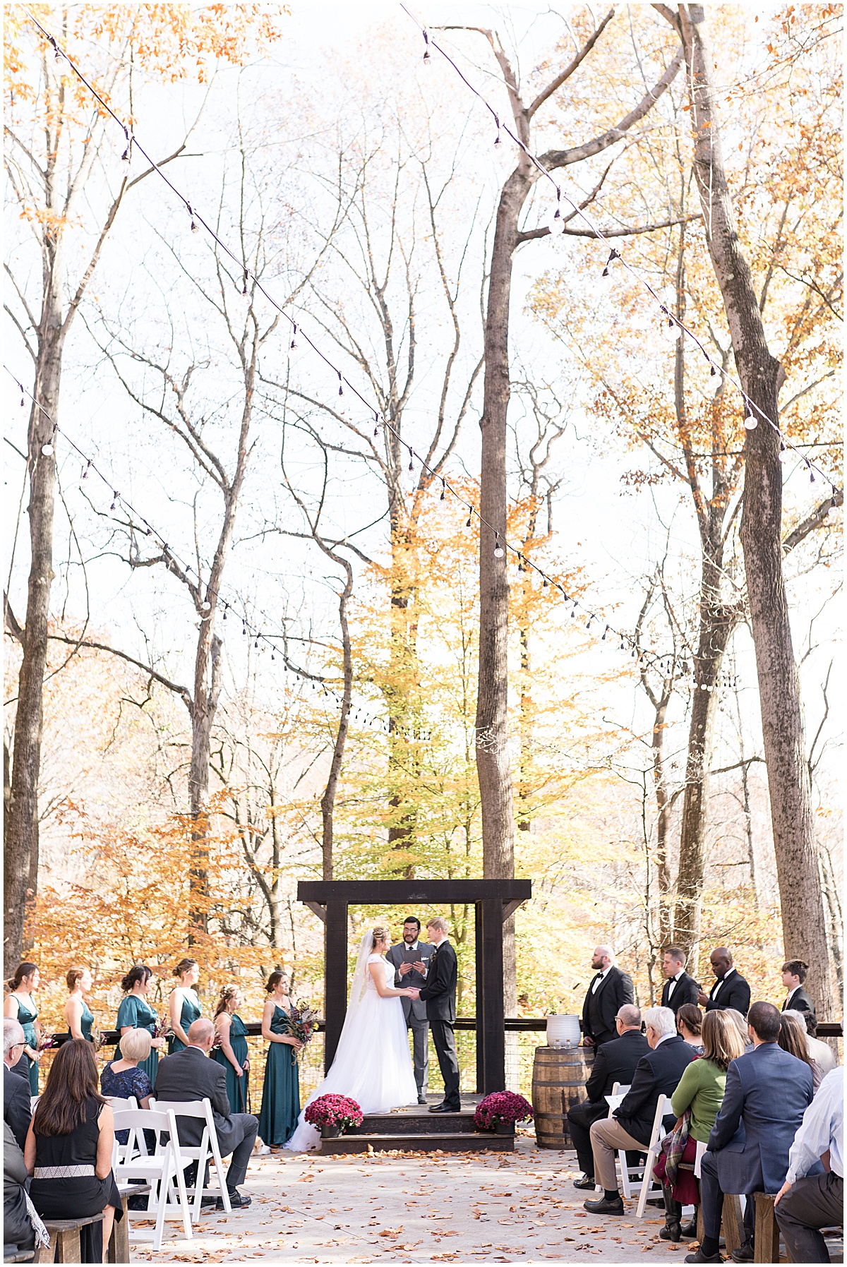Wedding ceremony in fall leaves at fall wedding at 3 Fat Labs in Greencastle, Indiana