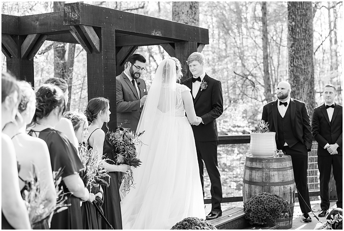 Couple exchanging vows at fall wedding at 3 Fat Labs in Greencastle, Indiana