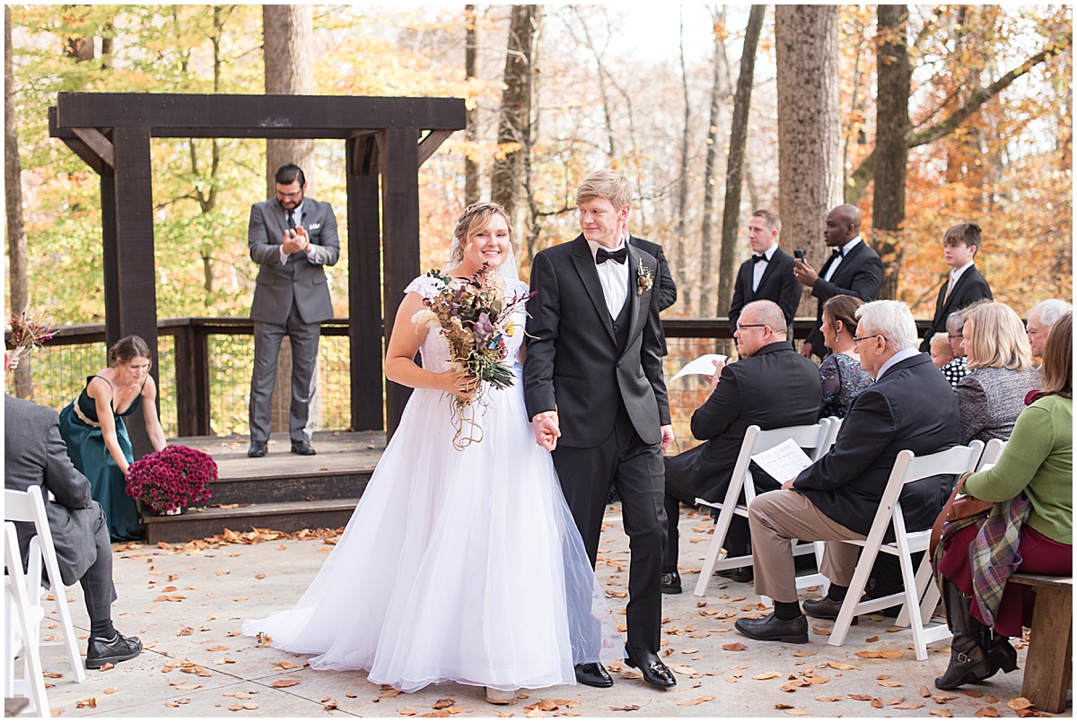 Bride and groom exit from fall wedding at 3 Fat Labs in Greencastle, Indiana