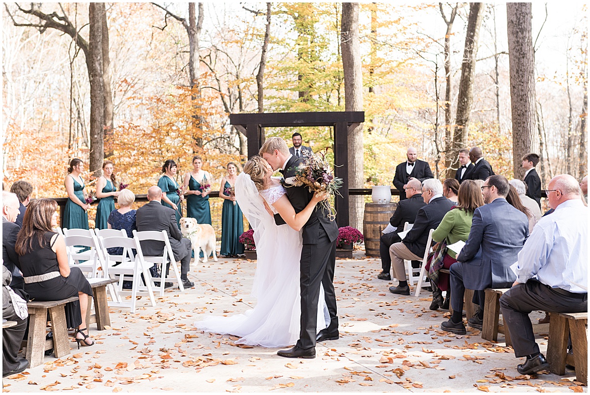 Bride and groom kiss after exit at fall wedding at 3 Fat Labs in Greencastle, Indiana