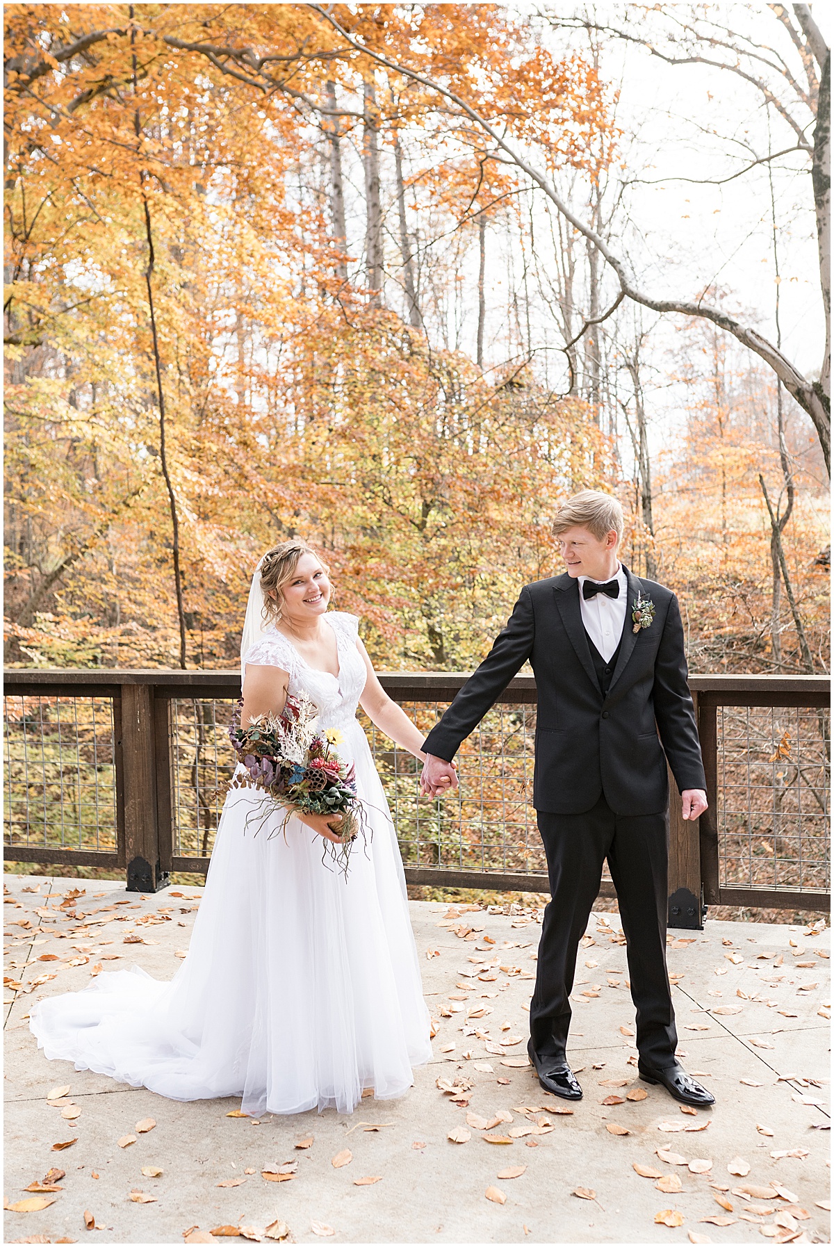 Couple holding hands at fall wedding at 3 Fat Labs in Greencastle, Indiana