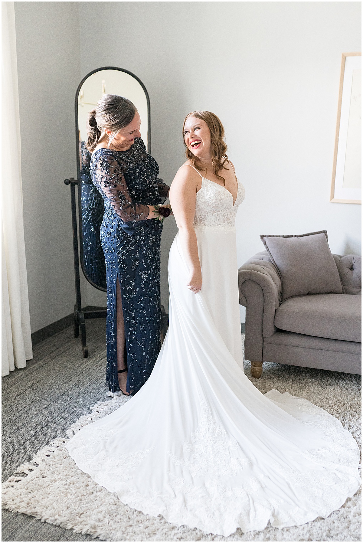 Bride laughing with mother before Iron & Ember events wedding in Carmel, Indiana