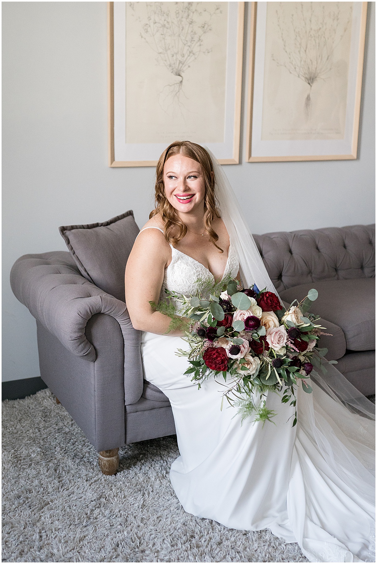 Bride sitting on sofa before Iron & Ember events wedding in Carmel, Indiana
