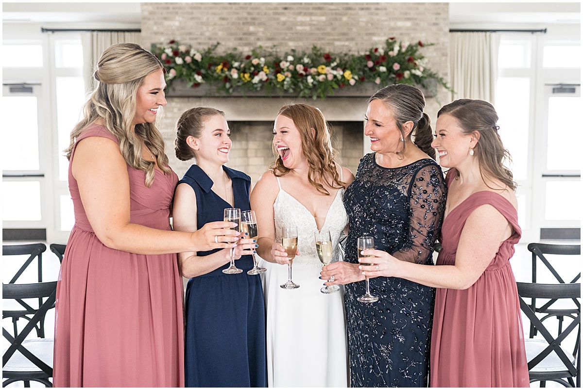 Bride celebrates with toast before Iron & Ember events wedding in Carmel, Indiana