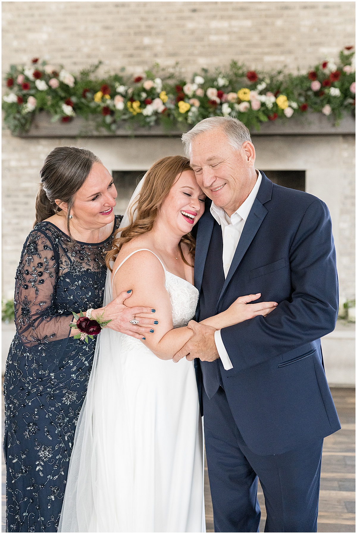 Bride hugs parents before Iron & Ember events wedding in Carmel, Indiana
