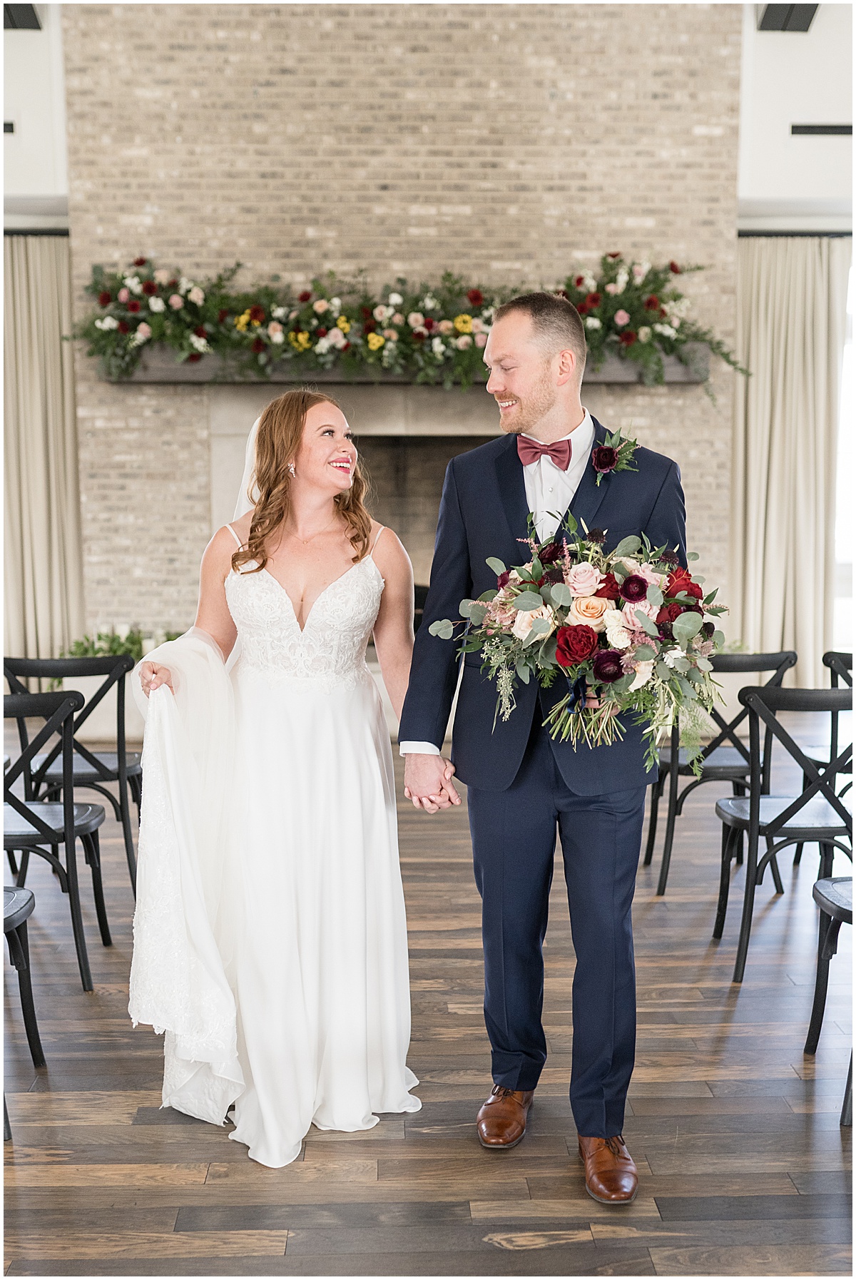 Bride and groom hold hands at Iron & Ember events wedding in Carmel, Indiana
