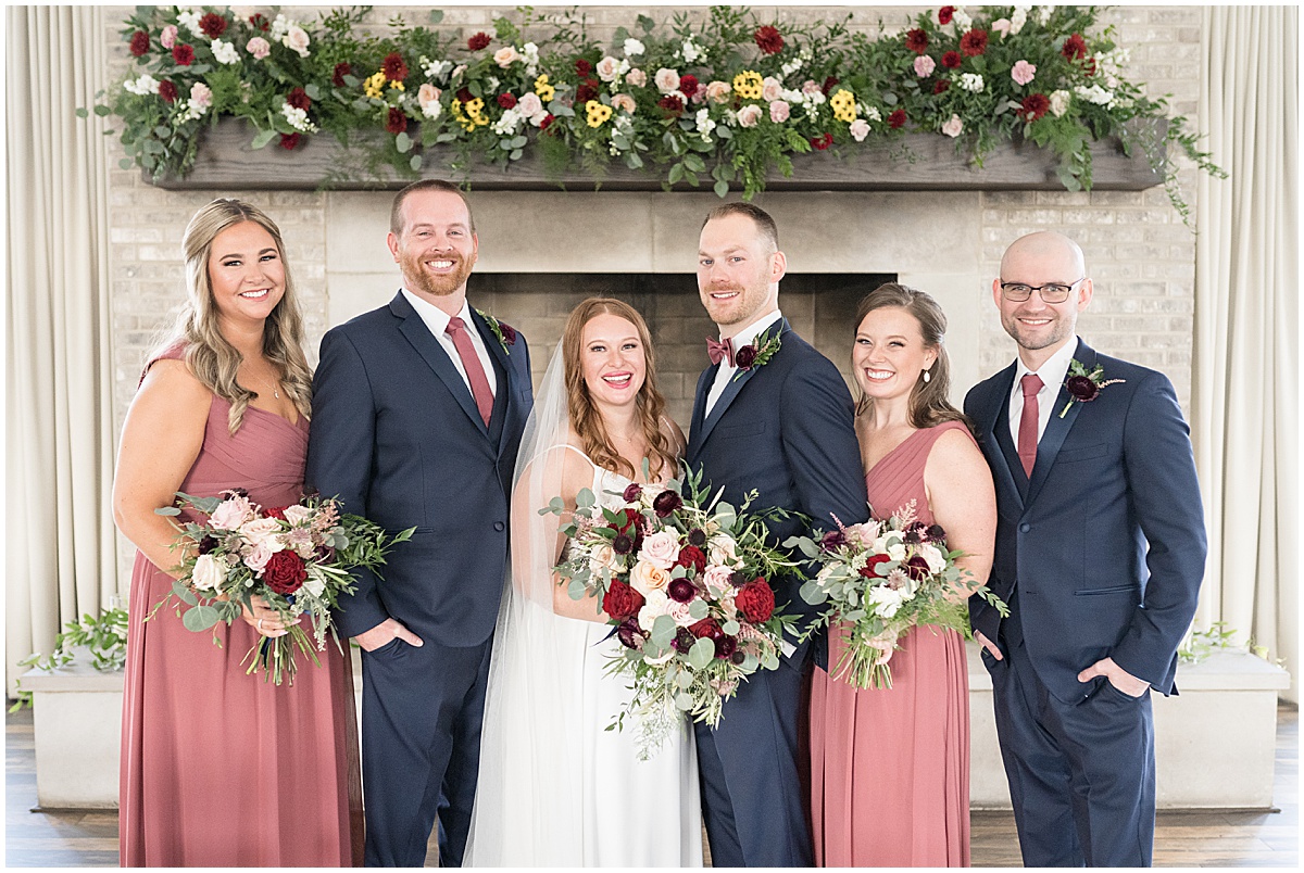 Full bridal party portrait wearing navy and pink at Iron & Ember events wedding in Carmel, Indiana
