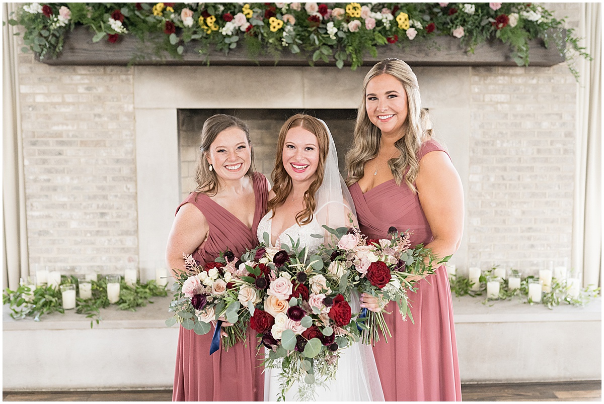 Bride with bridesmaids in pink dresses at Iron & Ember events wedding in Carmel, Indiana