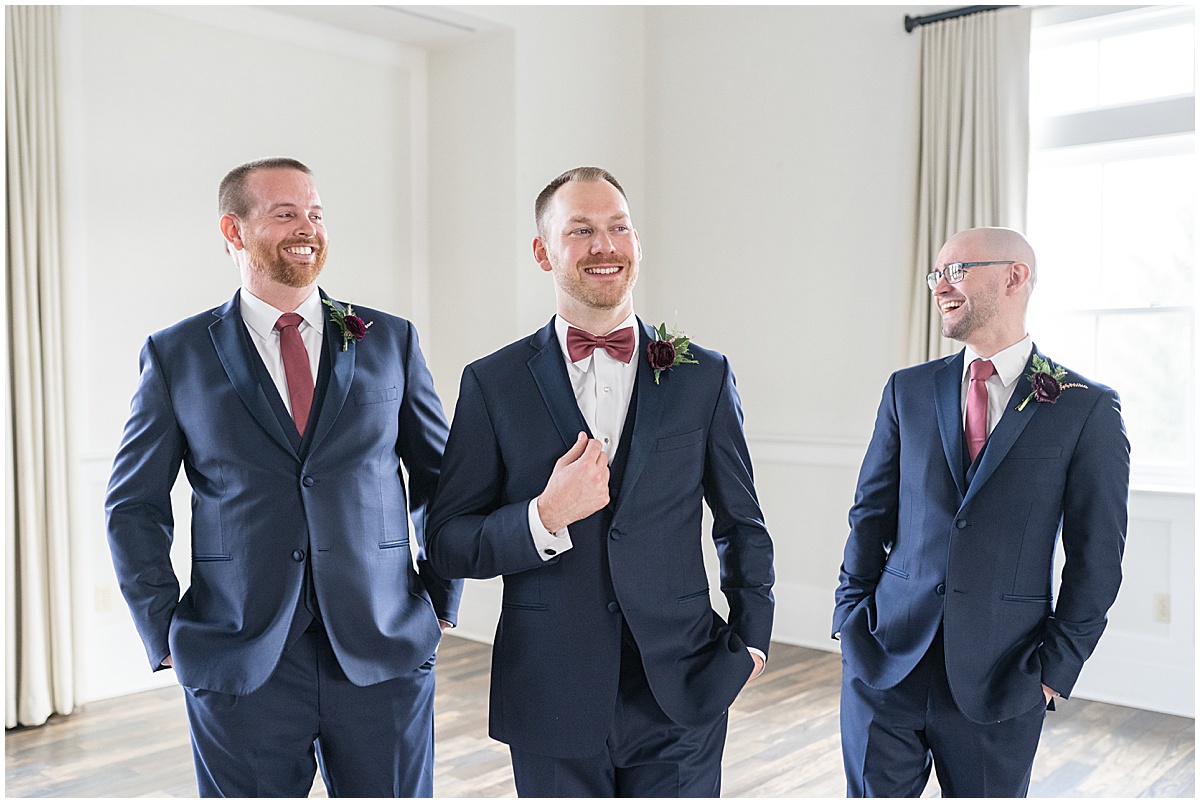 Groom laughing with groomsmen at Iron & Ember events wedding in Carmel, Indiana