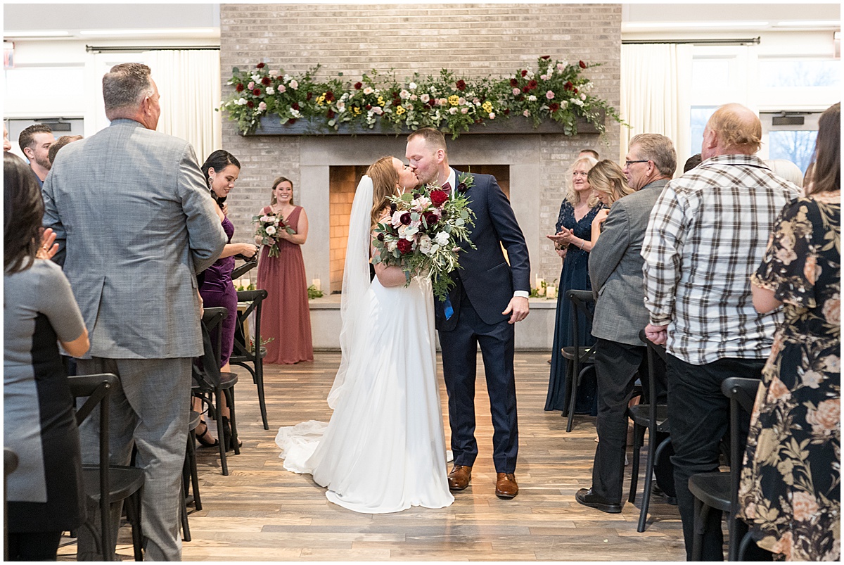 Bride and groom kiss at Iron & Ember events wedding in Carmel, Indiana