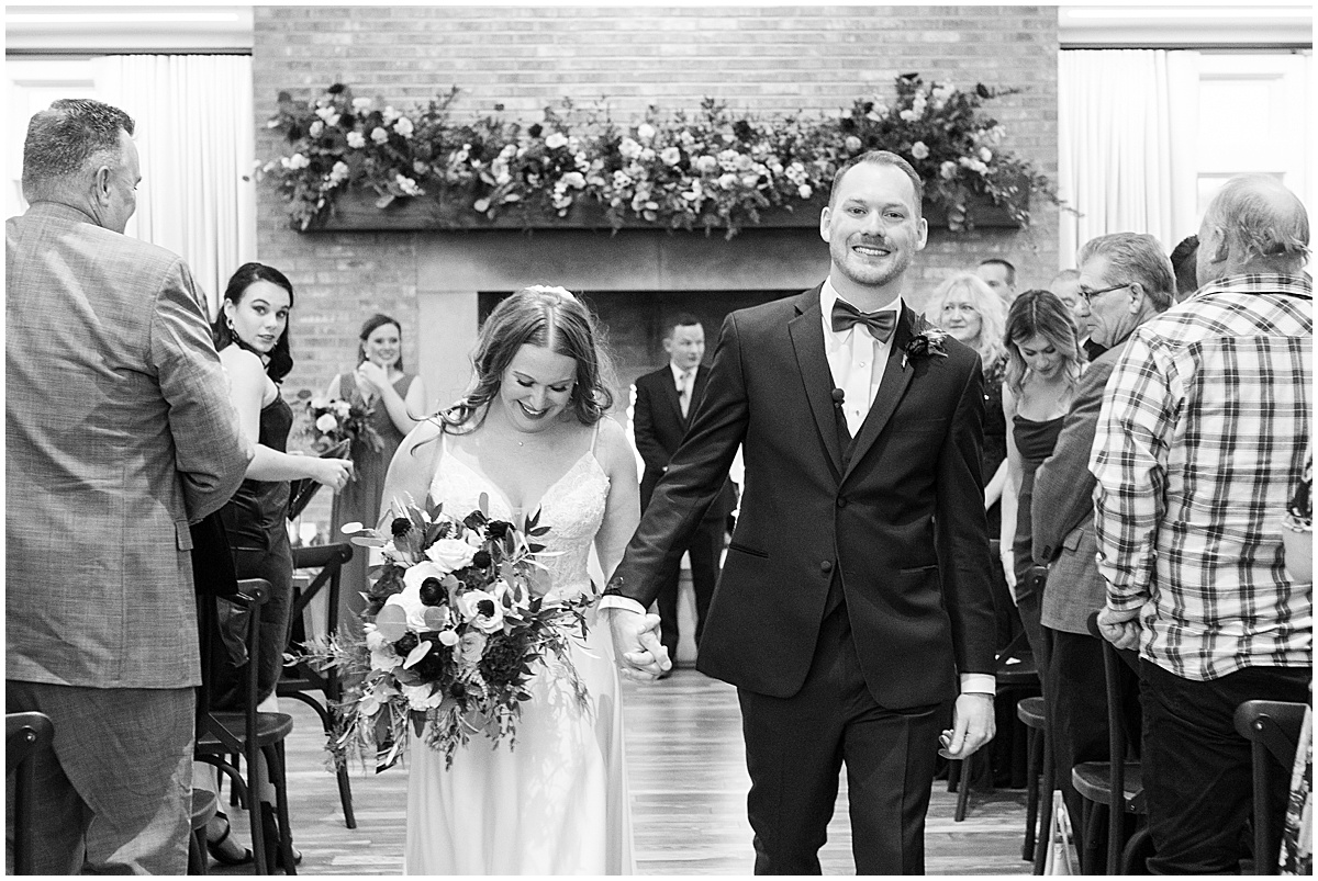 Newlyweds walk back down aisle at Iron & Ember events wedding in Carmel, Indiana