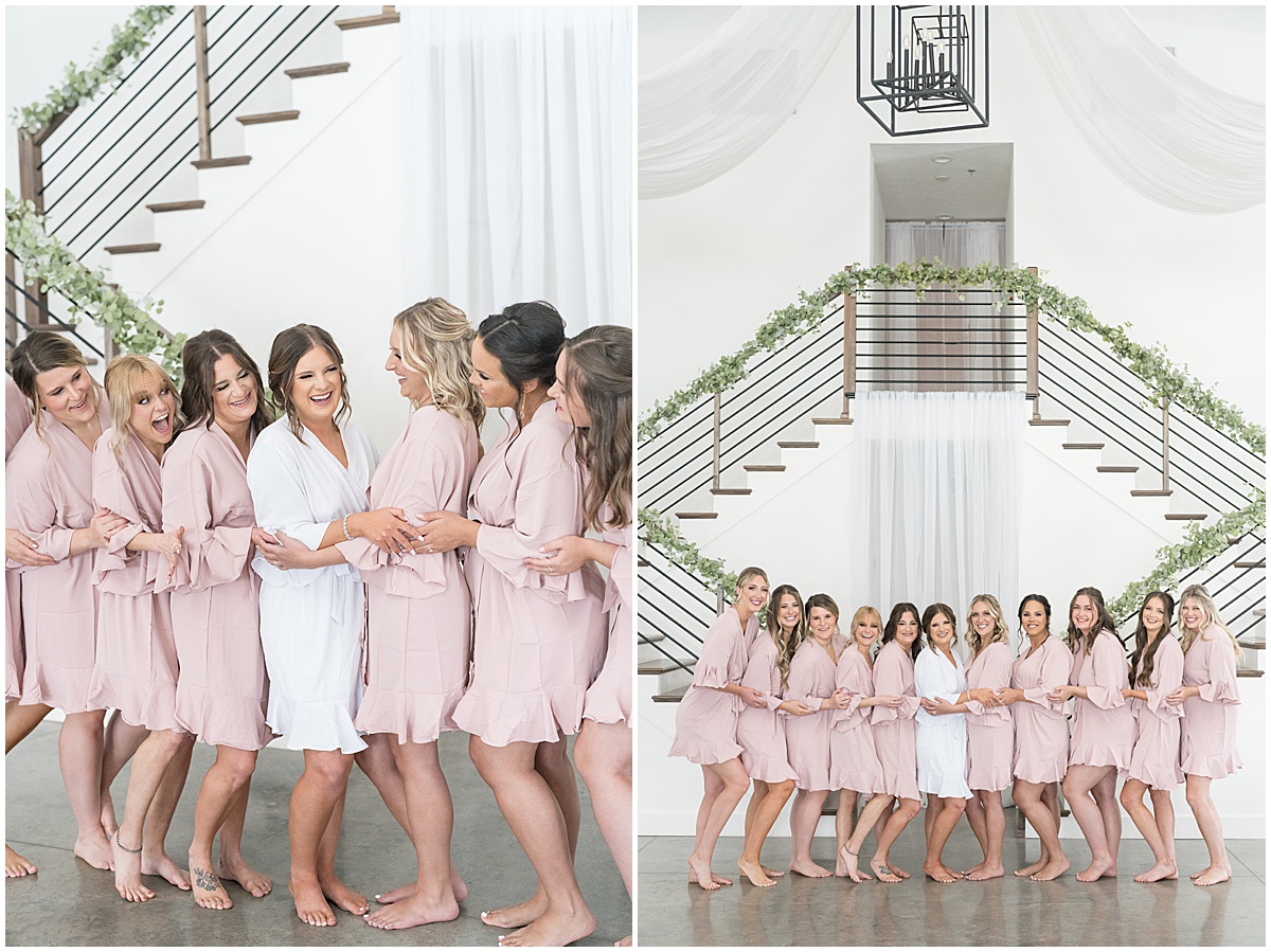 Bride with bridesmaids in matching robes before wedding at New Journey Farms