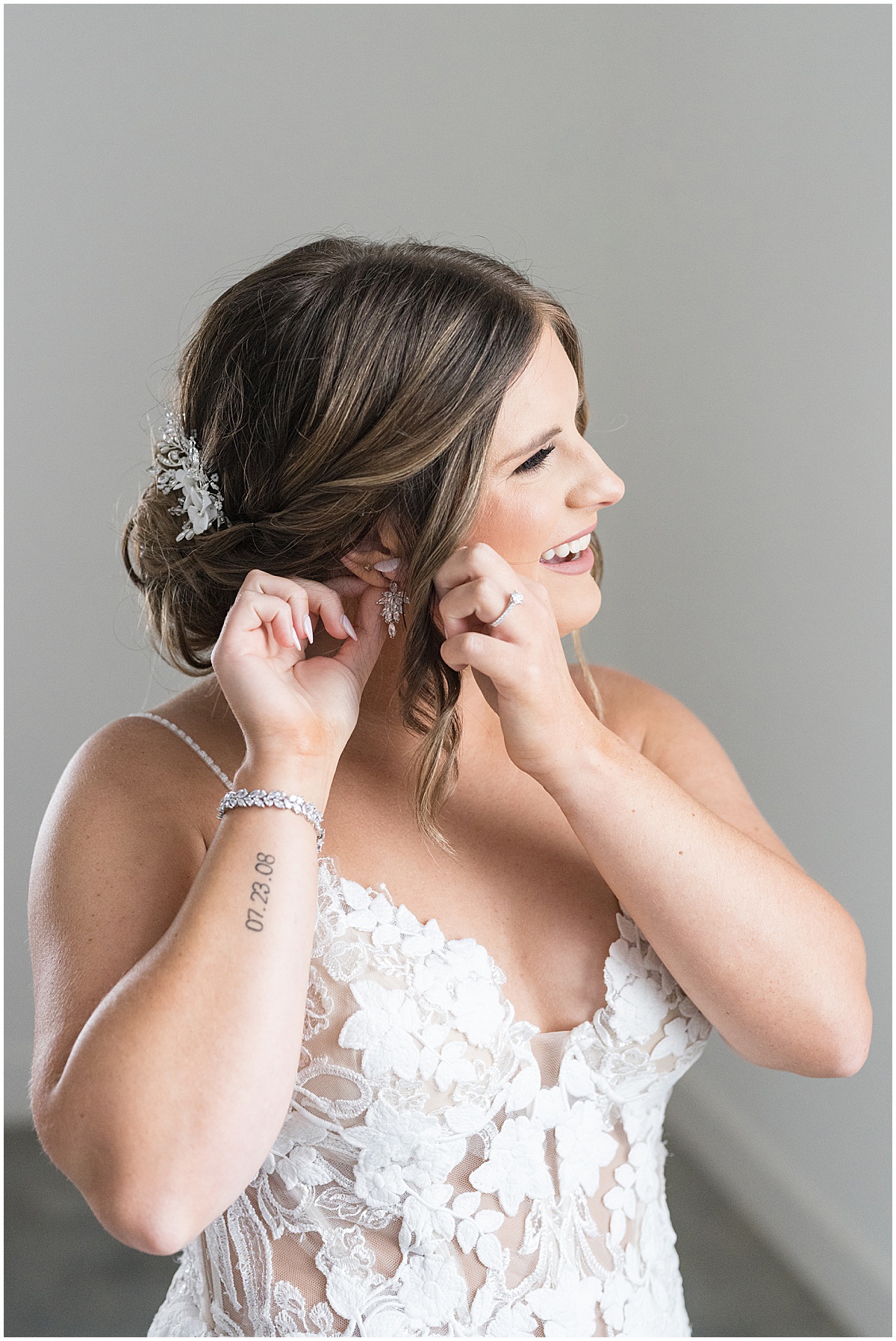 Bride puts on earrings for wedding at New Journey Farms