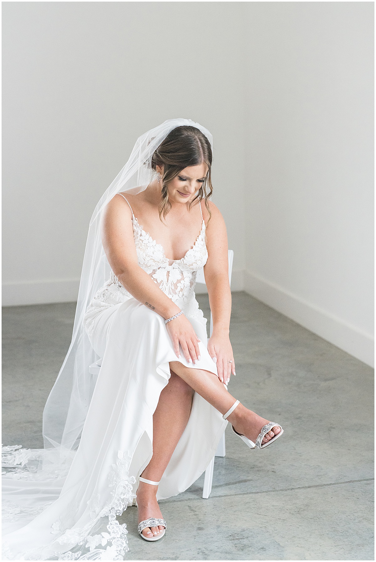 Bride puts on shoes for wedding at New Journey Farms