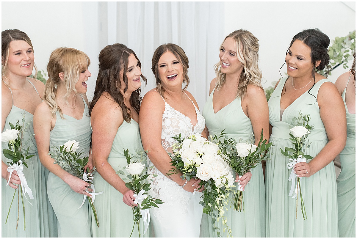 Bride laughs with bridesmaids at wedding at New Journey Farms
