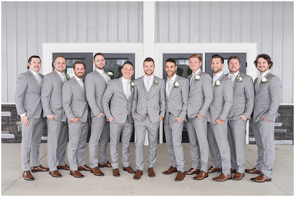 Groom with groomsmen outside of wedding at New Journey Farms