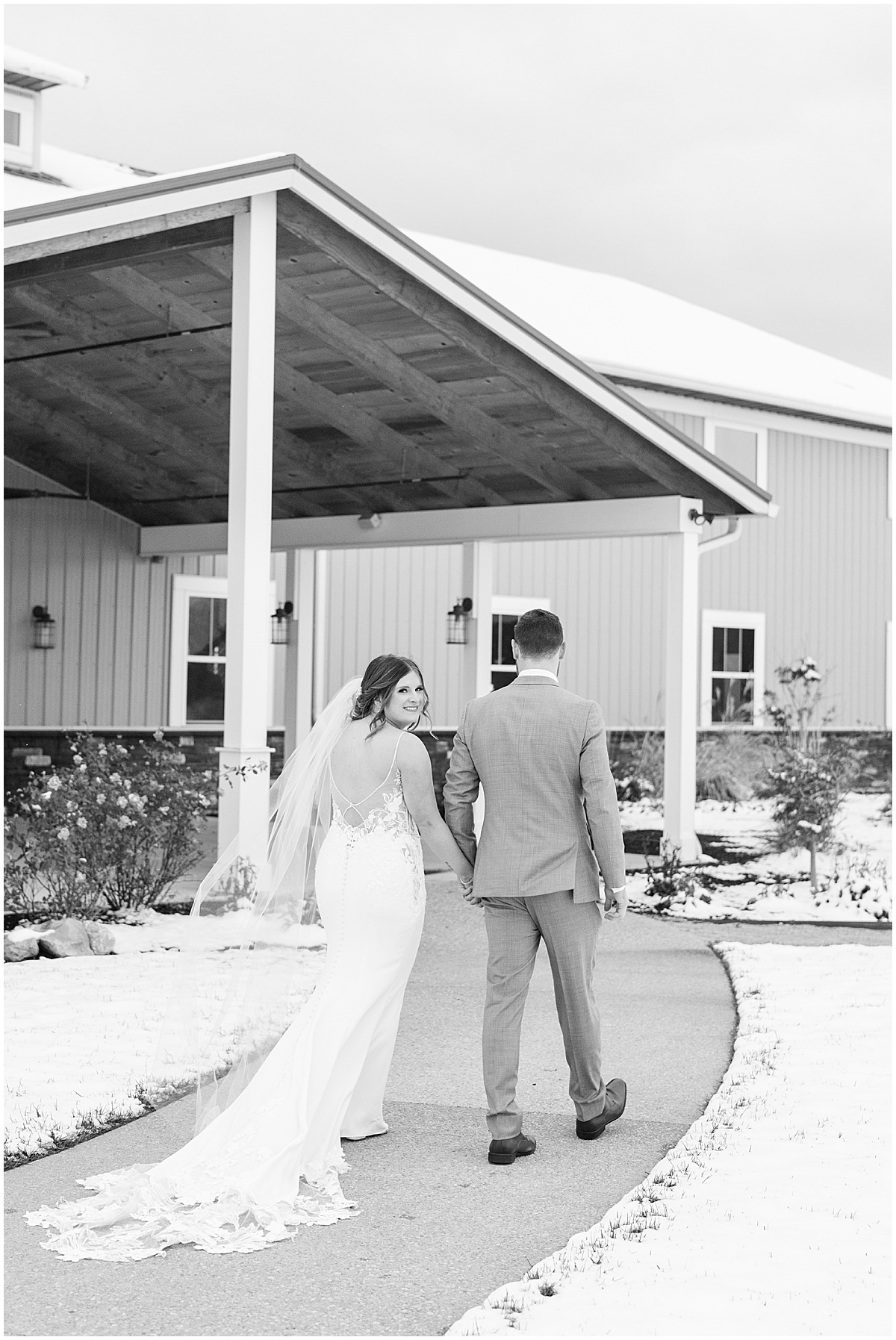 Bride and groom walk into venue for wedding at New Journey Farms