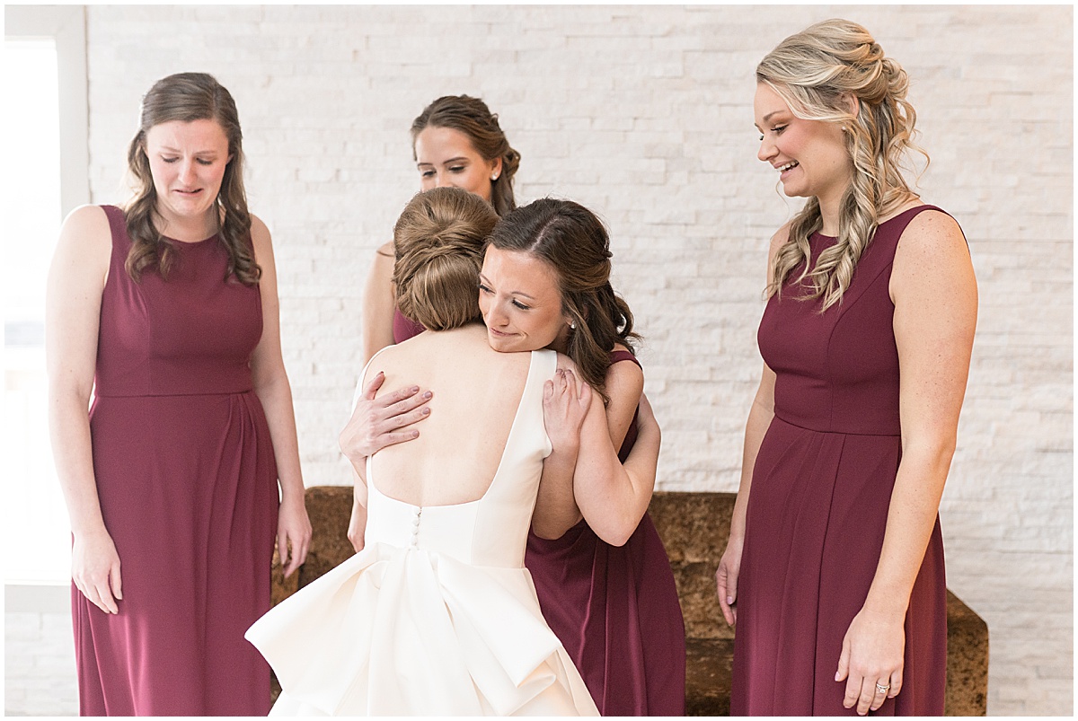 Bride hugs bridesmaids before Allure on the Lake wedding in Chesterton, Indiana
