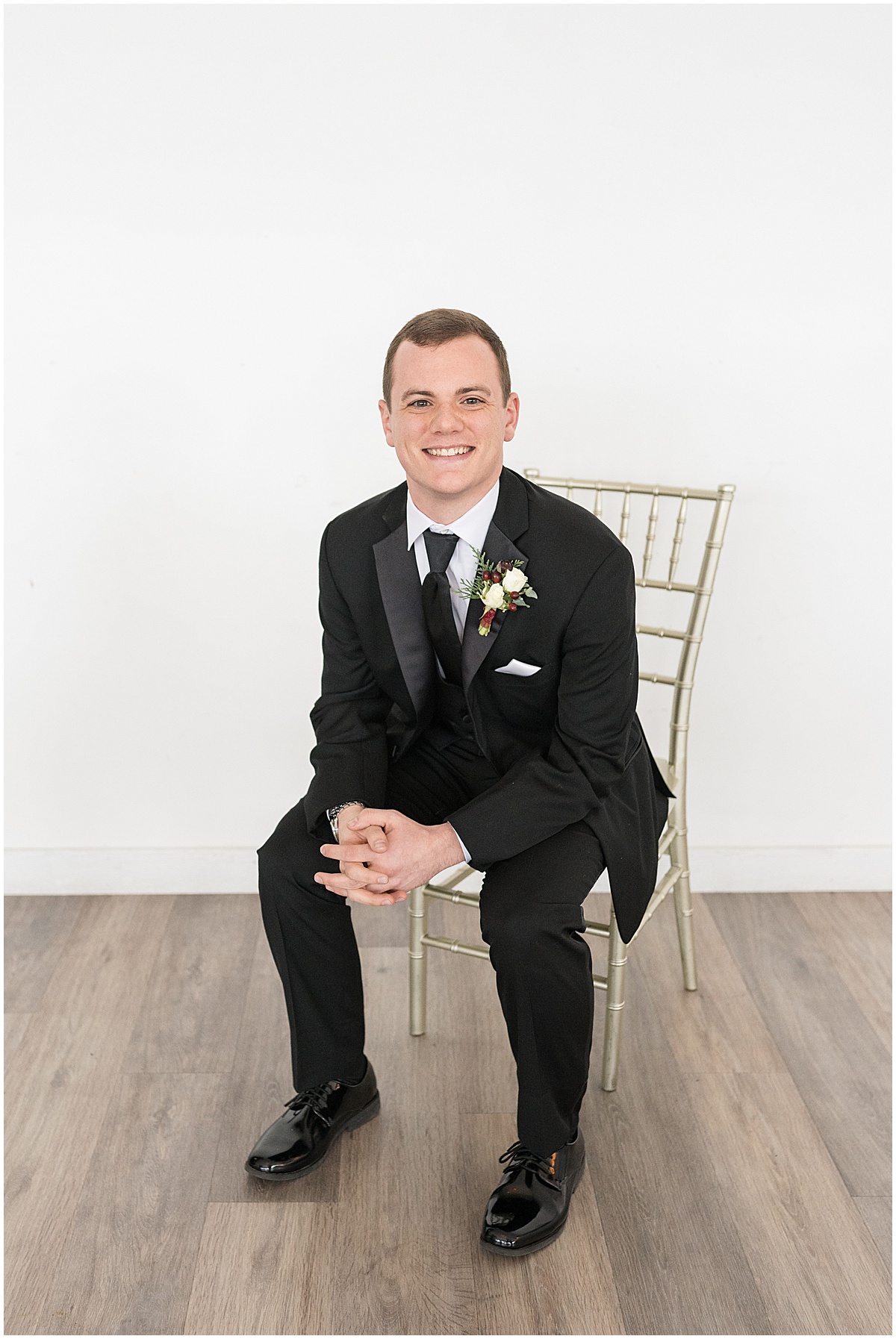 Groom sitting in chair before Allure on the Lake wedding in Chesterton, Indiana