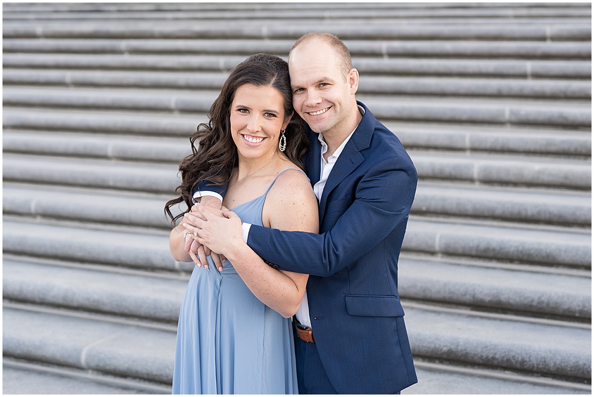 Couple hugs in front of steps at Indiana War Memorial during Downtown Engagement Photos