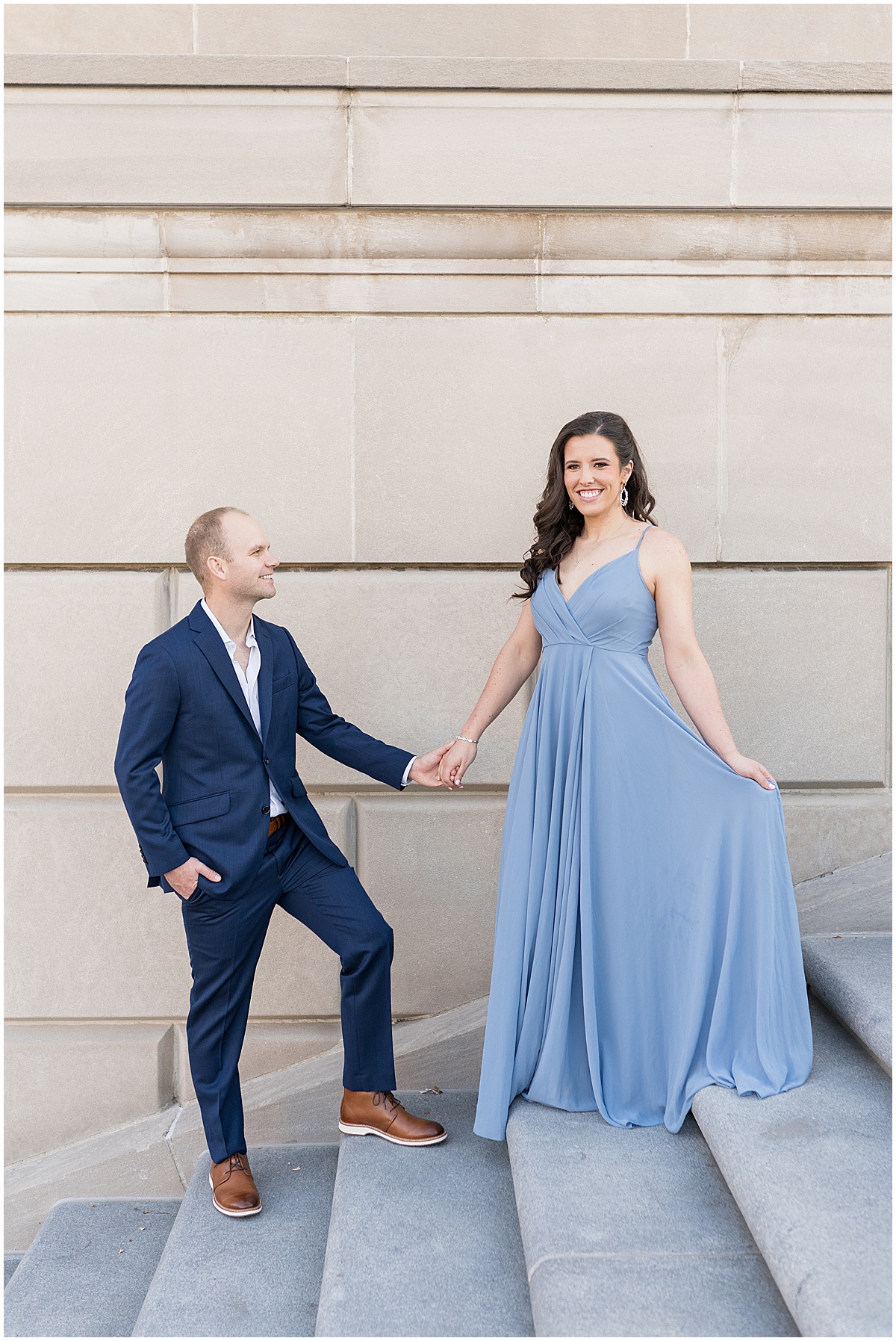 Couple walk up steps at Indiana War Memorial during Downtown Engagement Photos