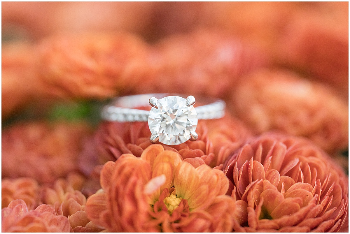 Close up of ring in orange flowers at White River State Park during Downtown Engagement Photos