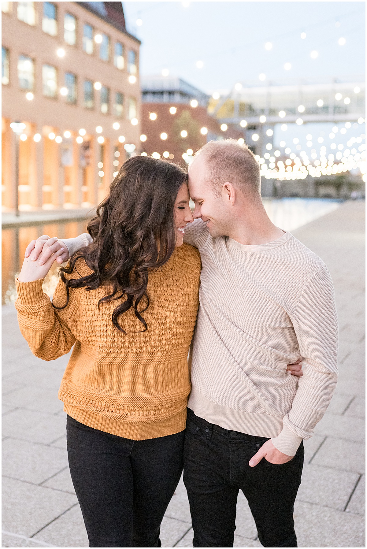 Couple get close on Indianapolis Canal Walk during Downtown Engagement Photos